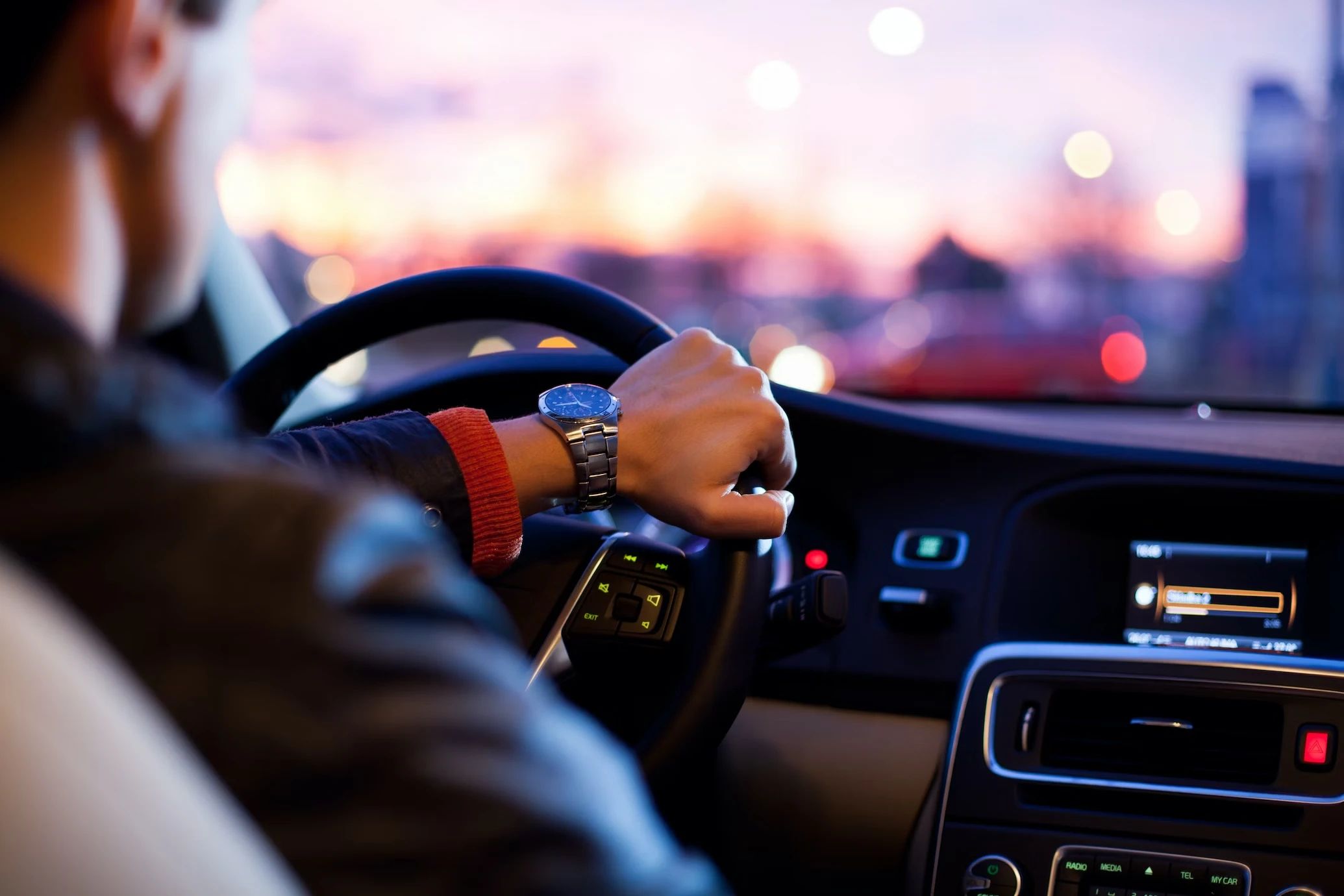 Driving a car at sunset
